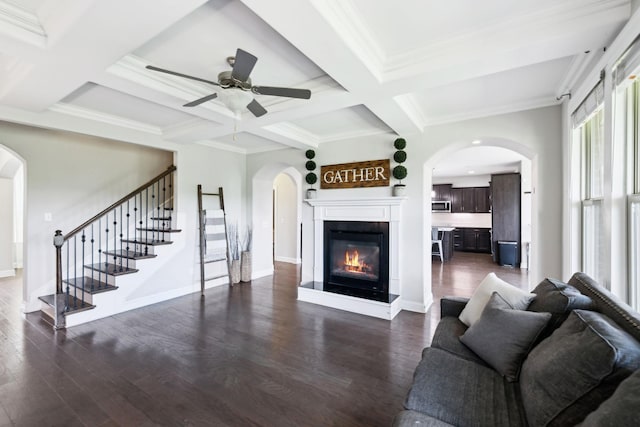743 Burgess Dr, Goodlettsville, TN 37072 - living area featuring plenty of natural light, arched walkways, stairway, dark wood finished floors, and beam ceiling