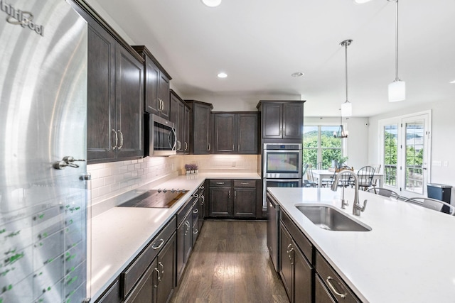 743 Burgess Dr, Goodlettsville, TN 37072 - kitchen with appliances with stainless steel finishes, a sink, light countertops, dark wood-type flooring, and dark brown cabinets