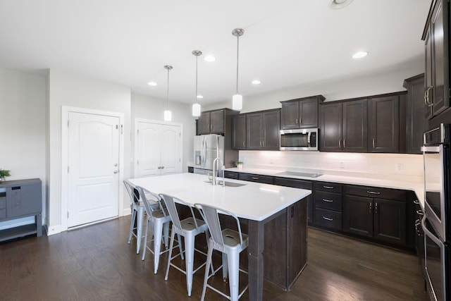 743 Burgess Dr, Goodlettsville, TN 37072 - kitchen featuring appliances with stainless steel finishes, a sink, dark wood-style flooring, a center island with sink, and recessed lighting