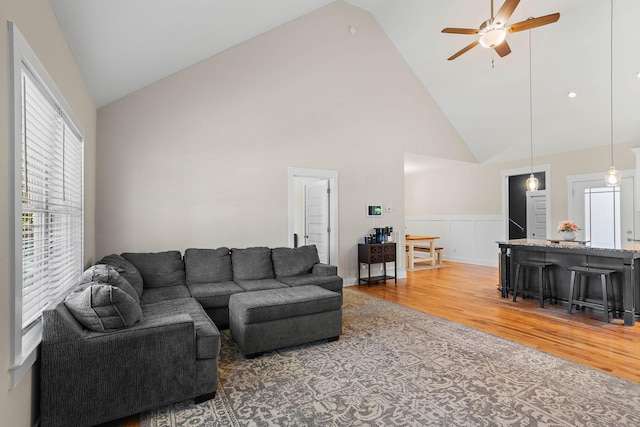 600 S Tunnel Rd, Gallatin, TN 37066 - living area featuring light wood-type flooring, a ceiling fan, high vaulted ceiling, a wainscoted wall, and a decorative wall