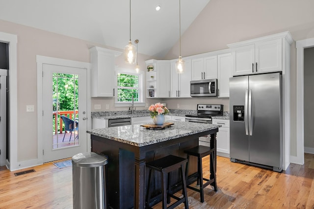 600 S Tunnel Rd, Gallatin, TN 37066 - kitchen featuring appliances with stainless steel finishes, white cabinets, light stone countertops, a center island, and a sink