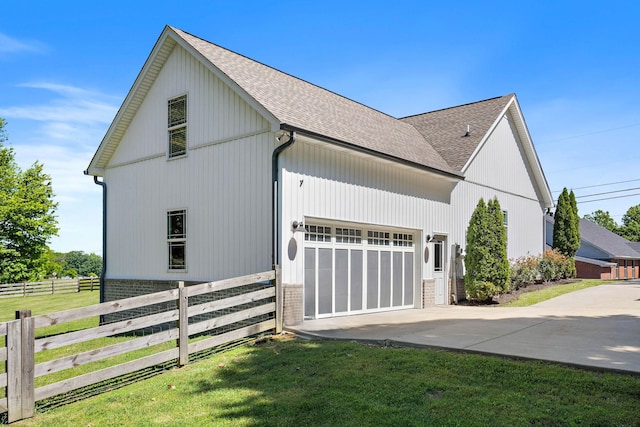 600 S Tunnel Rd, Gallatin, TN 37066 - view of side of home featuring a shingled roof, driveway, a garage, and brick siding