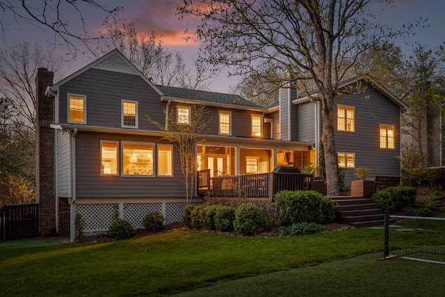 18 Whispering Pines Dr, Signal Mountain, TN 37377 - back of property at dusk featuring a chimney and a yard