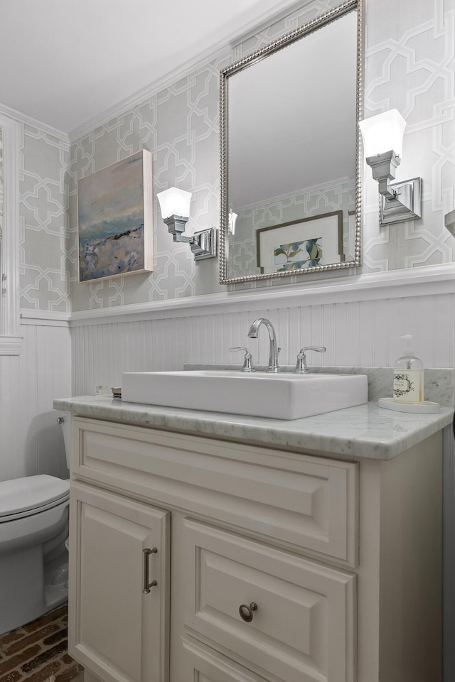 18 Whispering Pines Dr, Signal Mountain, TN 37377 - bathroom with vanity, toilet, brick flooring, a wainscoted wall, and wallpapered walls