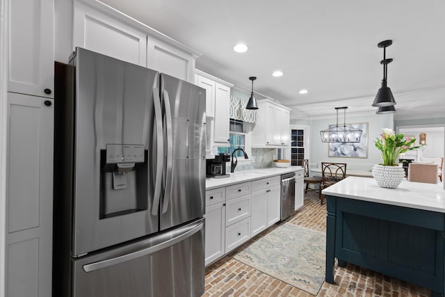 18 Whispering Pines Dr, Signal Mountain, TN 37377 - kitchen featuring appliances with stainless steel finishes, a sink, recessed lighting, brick flooring, and hanging light fixtures