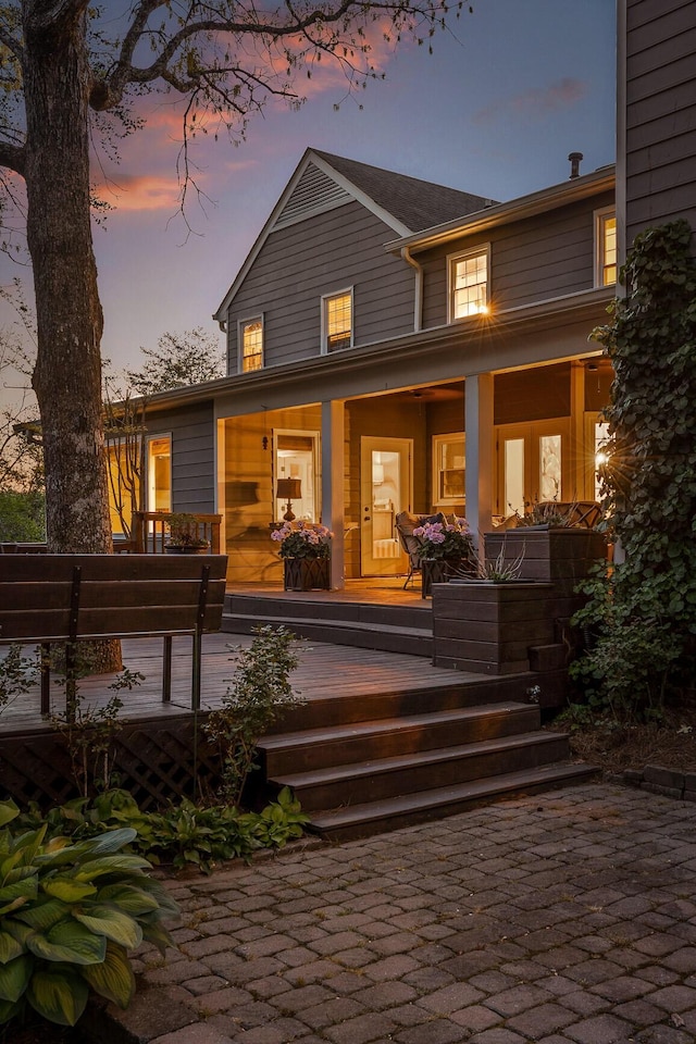 18 Whispering Pines Dr, Signal Mountain, TN 37377 - back of property at dusk featuring covered porch
