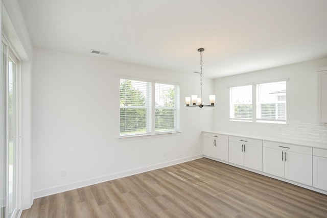 124 W Cassa Way, Mount Juliet, TN 37122 - unfurnished dining area featuring a chandelier, healthy amount of natural light, light wood finished floors, and baseboards