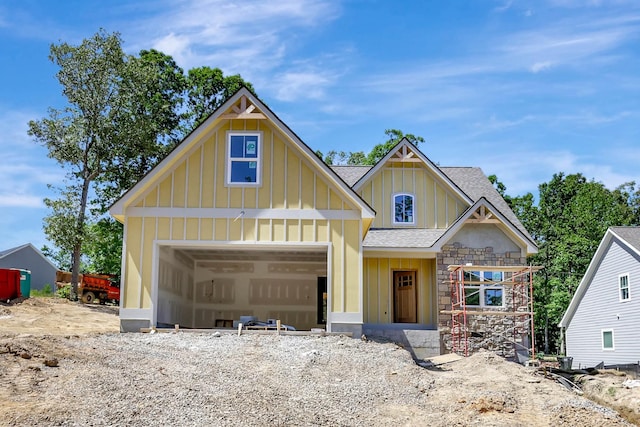 7585 Peytons Rise Way Lot # 29, Georgetown, TN 37336 - view of front facade featuring board and batten siding, roof with shingles, stone siding, and an attached garage