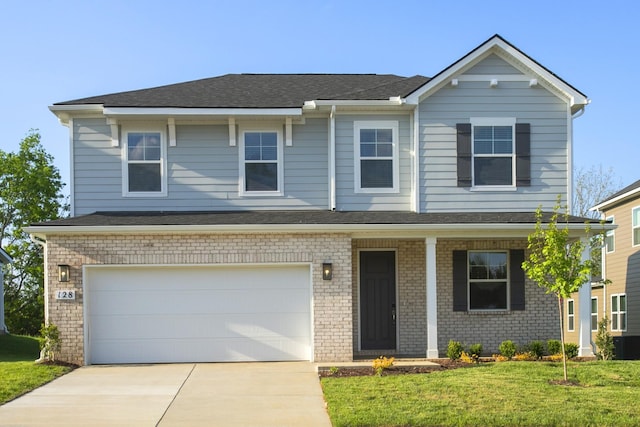 128 W Cassa Way, Mount Juliet, TN 37122 - view of front of property featuring driveway, a front yard, a garage, and a porch