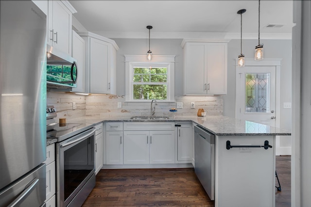 7112 Pepper Tree Cir, Fairview, TN 37062 - kitchen with appliances with stainless steel finishes, a sink, a peninsula, white cabinets, and decorative backsplash
