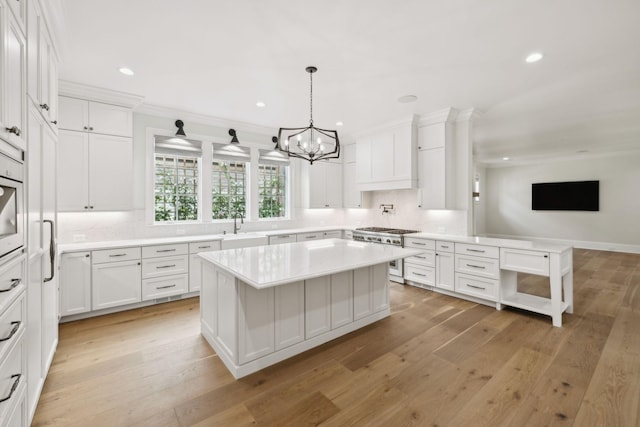304 Berry Cir, Franklin, TN 37064 - kitchen featuring high end stove, a sink, light countertops, a chandelier, and recessed lighting