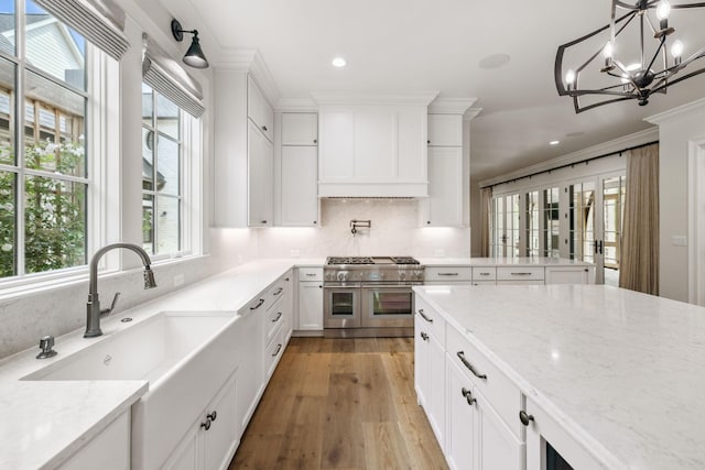 304 Berry Cir, Franklin, TN 37064 - kitchen featuring range with two ovens, recessed lighting, white cabinetry, a sink, and a chandelier