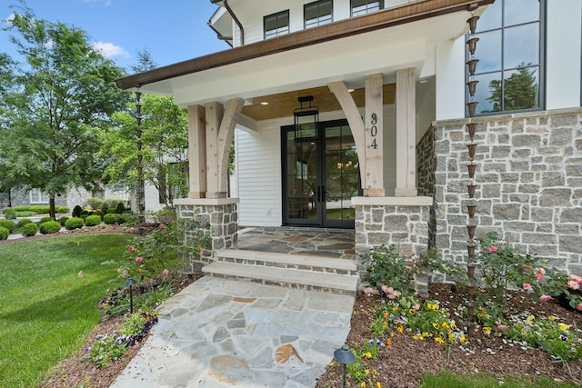 304 Berry Cir, Franklin, TN 37064 - view of exterior entry with a porch, stone siding, and a lawn