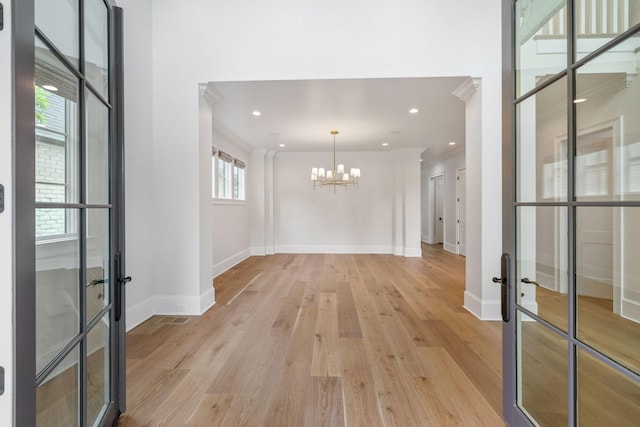 304 Berry Cir, Franklin, TN 37064 - hallway featuring french doors, a chandelier, crown molding, light wood finished floors, and baseboards