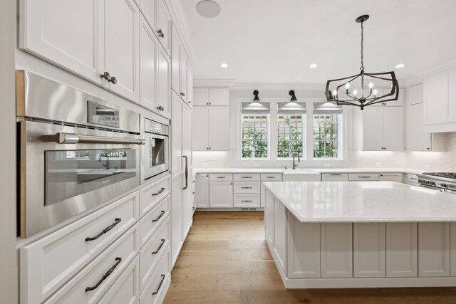 304 Berry Cir, Franklin, TN 37064 - kitchen featuring a sink, a chandelier, white cabinetry, a kitchen island, and recessed lighting