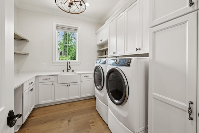 304 Berry Cir, Franklin, TN 37064 - washroom with cabinet space, washer and clothes dryer, crown molding, light wood finished floors, and a chandelier