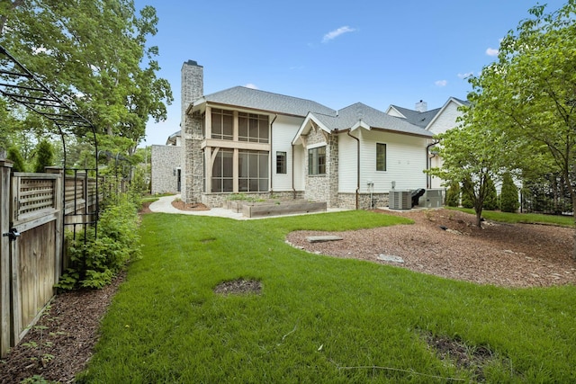 304 Berry Cir, Franklin, TN 37064 - back of house with a chimney, central air condition unit, and stone siding