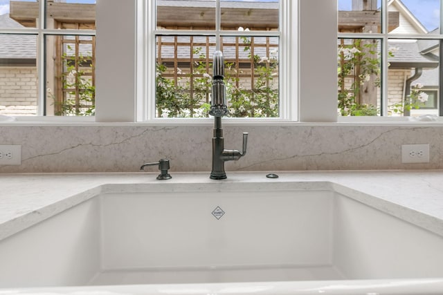 304 Berry Cir, Franklin, TN 37064 - detailed view of a sink, decorative backsplash, and light stone countertops