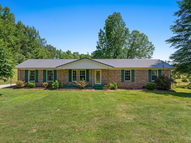 6205 Pumping Station Rd, Cypress Inn, TN 38452 - ranch-style home featuring a front lawn, brick siding, and metal roof