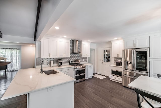 116 Jackson Ln, Hendersonville, TN 37075 - kitchen with appliances with stainless steel finishes, a sink, a peninsula, wall chimney exhaust hood, and backsplash