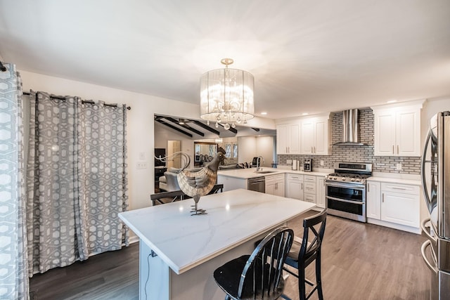 116 Jackson Ln, Hendersonville, TN 37075 - kitchen featuring appliances with stainless steel finishes, wall chimney exhaust hood, wood finished floors, and a sink