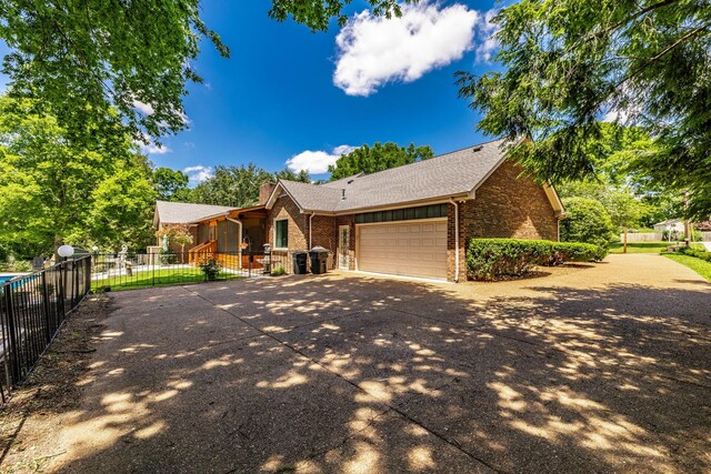 116 Jackson Ln, Hendersonville, TN 37075 - ranch-style house featuring brick siding, driveway, an attached garage, and roof with shingles