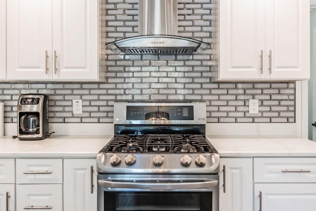 116 Jackson Ln, Hendersonville, TN 37075 - kitchen with stainless steel gas range, wall chimney exhaust hood, decorative backsplash, white cabinetry, and light stone counters