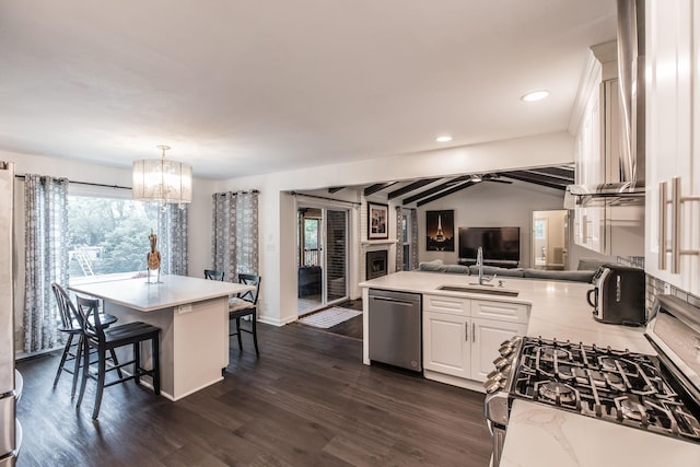 116 Jackson Ln, Hendersonville, TN 37075 - kitchen featuring stainless steel appliances, lofted ceiling, a fireplace, light countertops, and white cabinets