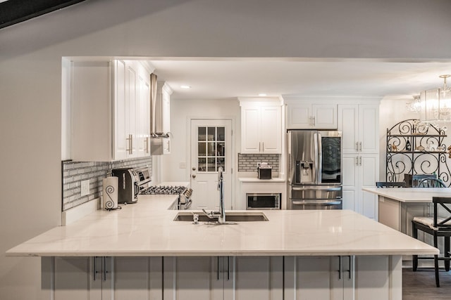 116 Jackson Ln, Hendersonville, TN 37075 - kitchen featuring stainless steel appliances, a sink, a peninsula, decorative backsplash, and white cabinetry