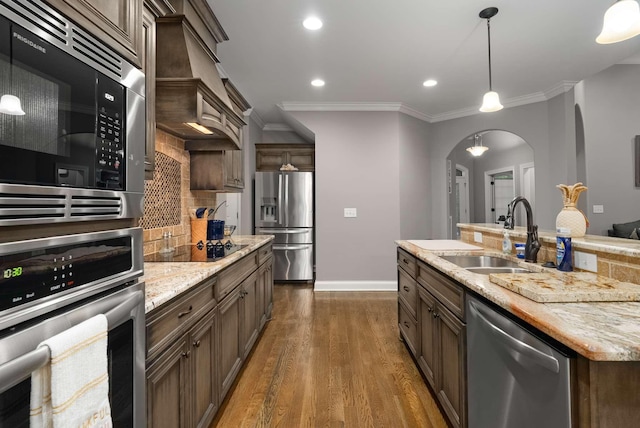 117 Brixton Rdg, Lebanon, TN 37087 - kitchen with stainless steel appliances, a sink, arched walkways, decorative backsplash, and dark wood-style floors