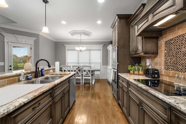 117 Brixton Rdg, Lebanon, TN 37087 - kitchen with a sink, stainless steel appliances, dark brown cabinetry, decorative backsplash, and pendant lighting