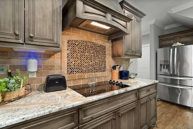 117 Brixton Rdg, Lebanon, TN 37087 - kitchen with stainless steel fridge, black electric cooktop, crown molding, decorative backsplash, and premium range hood