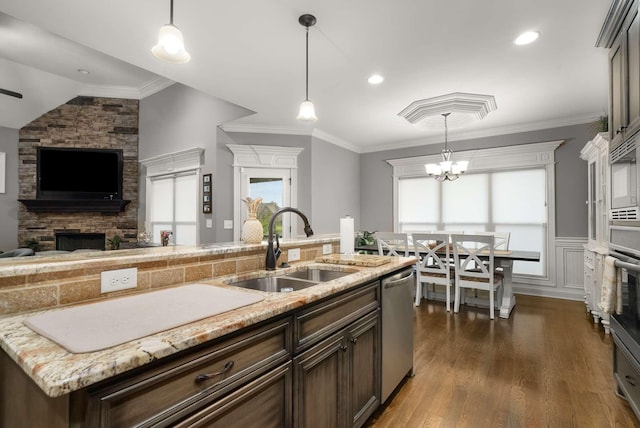 117 Brixton Rdg, Lebanon, TN 37087 - kitchen with a sink, stainless steel dishwasher, a stone fireplace, open floor plan, and dark brown cabinetry