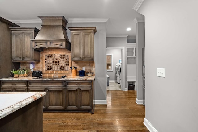 117 Brixton Rdg, Lebanon, TN 37087 - kitchen with separate washer and dryer, premium range hood, ornamental molding, backsplash, and dark wood finished floors