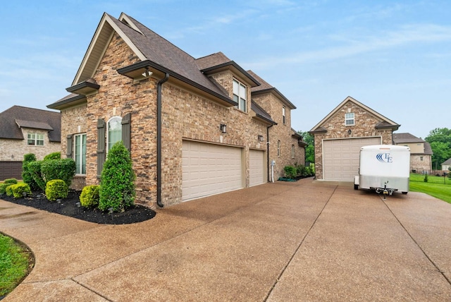 117 Brixton Rdg, Lebanon, TN 37087 - view of side of property with driveway, stone siding, and roof with shingles