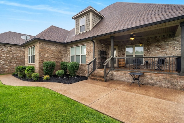 117 Brixton Rdg, Lebanon, TN 37087 - view of front of house with a shingled roof, brick siding, a front lawn, and a porch