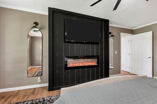 1800 Old Highway 52, Lafayette, TN 37083 - bedroom featuring baseboards, wood finished floors, ornamental molding, a large fireplace, and a ceiling fan