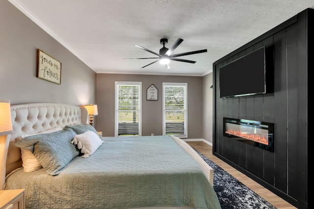 1800 Old Highway 52, Lafayette, TN 37083 - bedroom with ornamental molding, light wood-style floors, a fireplace, ceiling fan, and baseboards