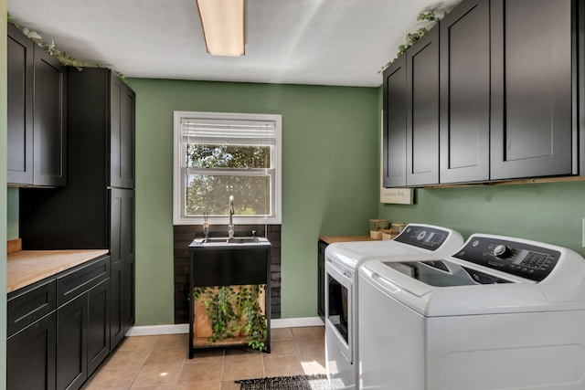 1800 Old Highway 52, Lafayette, TN 37083 - laundry area featuring cabinet space, washing machine and clothes dryer, light tile patterned floors, and baseboards