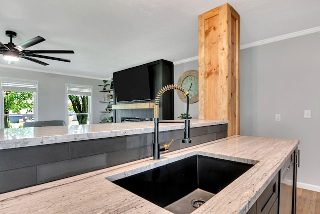 1800 Old Highway 52, Lafayette, TN 37083 - kitchen featuring a sink, crown molding, wood finished floors, light stone countertops, and baseboards