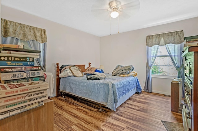 300 Troy Ln, Hohenwald, TN 38462 - bedroom featuring wood finished floors, a ceiling fan, and baseboards