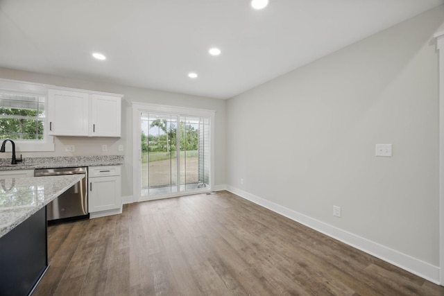 1917 Lewter Dr, Clarksville, TN 37042 - kitchen featuring dishwasher, baseboards, white cabinets, light stone counters, and wood finished floors