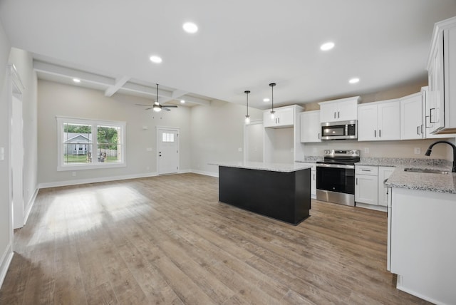 1917 Lewter Dr, Clarksville, TN 37042 - kitchen with appliances with stainless steel finishes, a sink, recessed lighting, beamed ceiling, and ceiling fan