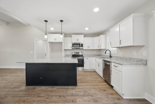 1917 Lewter Dr, Clarksville, TN 37042 - kitchen with appliances with stainless steel finishes, recessed lighting, a sink, baseboards, and a kitchen island