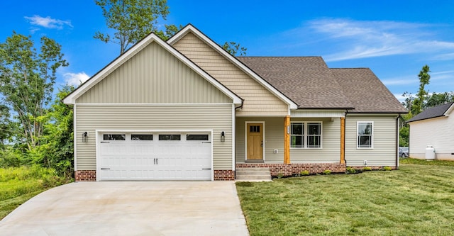 1917 Lewter Dr, Clarksville, TN 37042 - view of front facade with a garage, covered porch, a front lawn, and concrete driveway