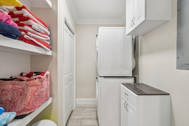 424 Wild Elm St, Franklin, TN 37064 - laundry room with stacked washer and clothes dryer, crown molding, cabinet space, and baseboards