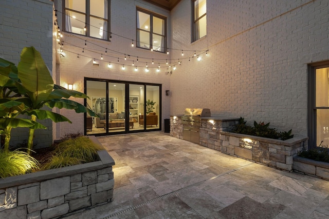 424 Wild Elm St, Franklin, TN 37064 - view of exterior entry featuring area for grilling, a patio area, and brick siding