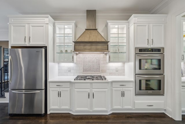 424 Wild Elm St, Franklin, TN 37064 - kitchen featuring stainless steel appliances, white cabinets, light countertops, backsplash, and crown molding
