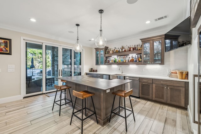 424 Wild Elm St, Franklin, TN 37064 - kitchen featuring stainless steel dishwasher, light wood-style floors, open shelves, a kitchen bar, and decorative backsplash