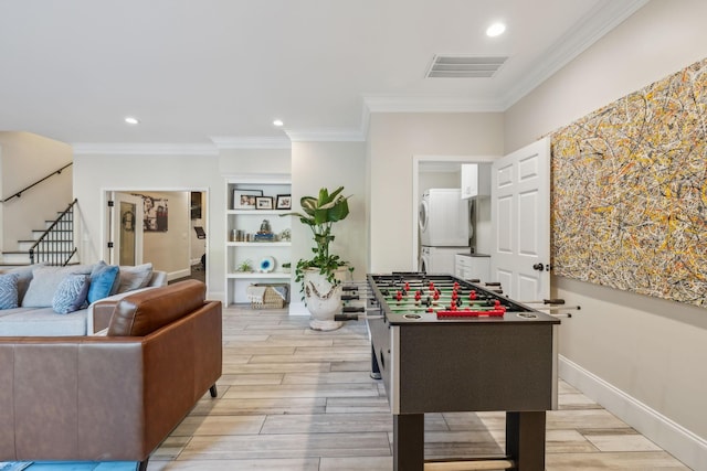 424 Wild Elm St, Franklin, TN 37064 - game room featuring crown molding, light wood-type flooring, stacked washer and clothes dryer, and recessed lighting